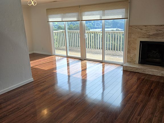 Living room with fireplace and balcony