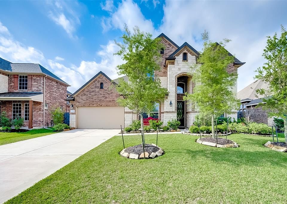 Gorgeous 2-story home with handsome brick and stone elevation. Attractive gabled roofing and soaring arched porch add to the stunning curb appeal.