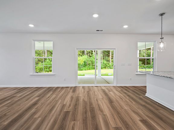 Spacious Pritchard living room with sliding glass door for easy outdoor access