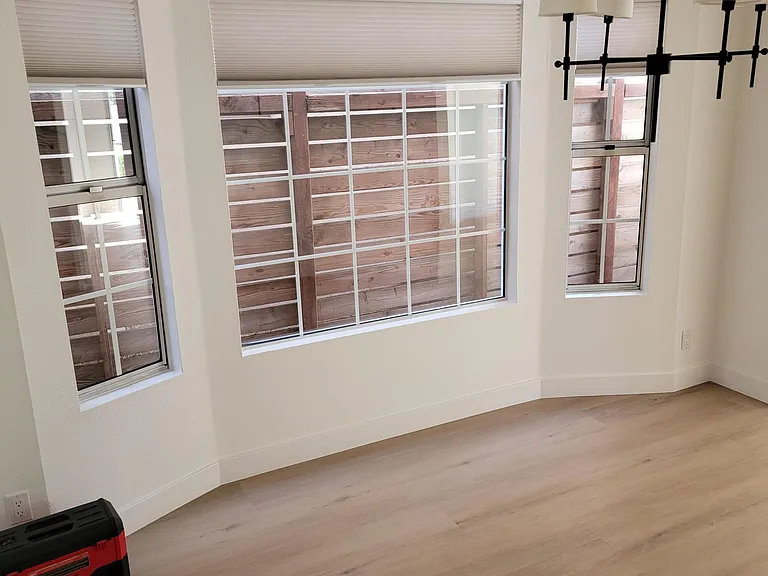 Dining room view with all new window coverings through out home.