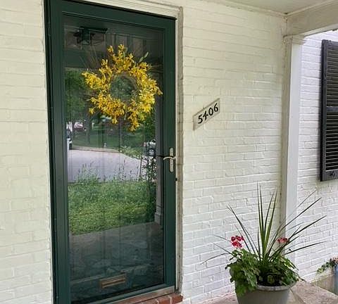 Front door with storm door and covered porch
