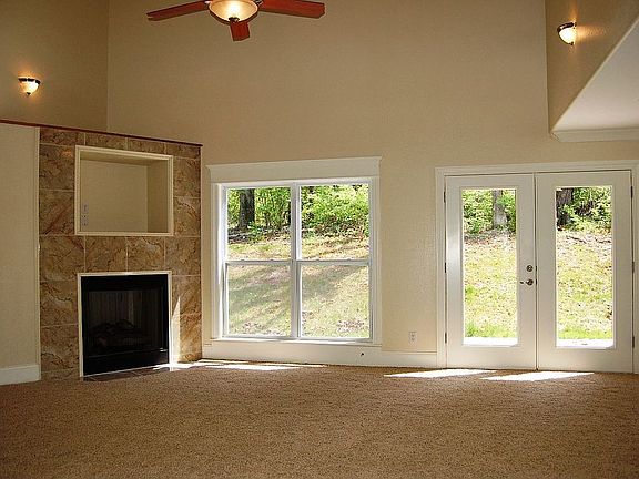 Living room offers large windows and a gas fire place