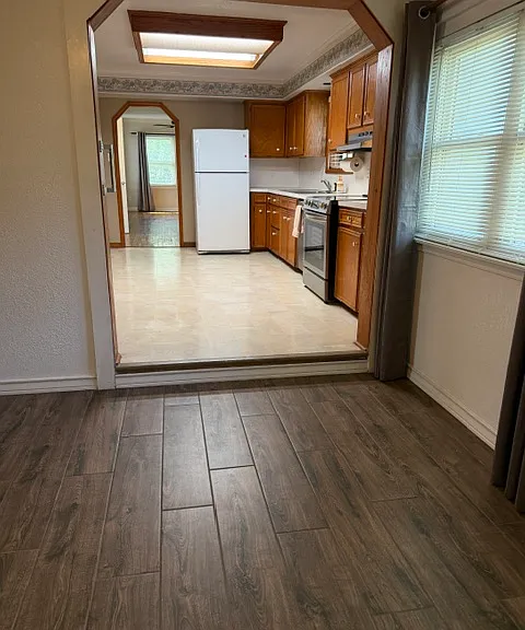 Kitchen is located between breakfast room and living room. It is large enough for central table or portable island.