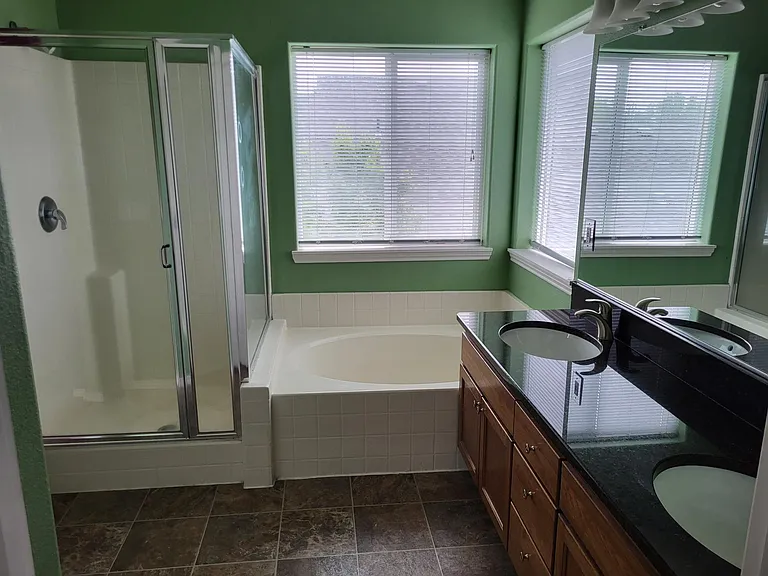 Master bath with walk in shower, soaking tub, dual bowl under mount sinks with granite counters
