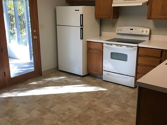 Kitchen with fridge/freezer, range, dishwasher, disposal, and microwave with door to three-season sunroom