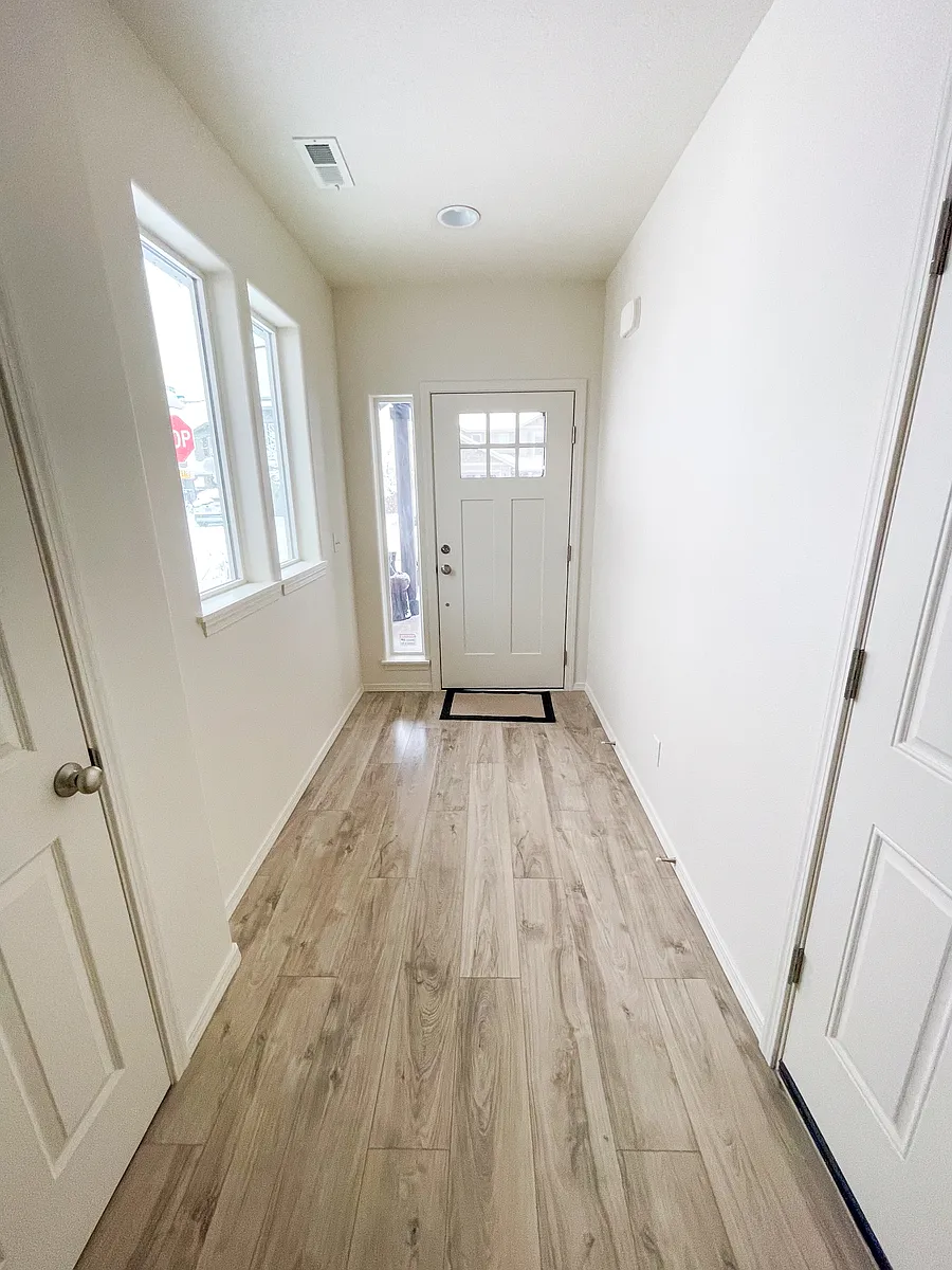 Hallway which showcases the natural light and color of walls and flooring throught the home. NOTE: Horizontal blinds currently under installation. - 21128 Azalia Ave