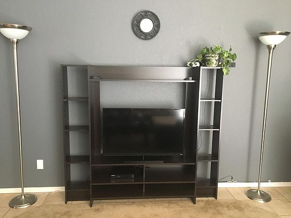 Living Room and entertainment center with Vizio TV.