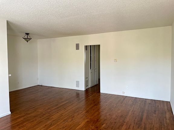 Large living room with space for a dining area/kitchen nook.