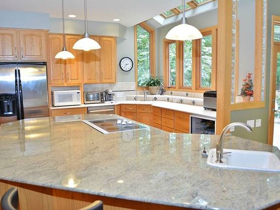 Granite island with prep sink and cook top.