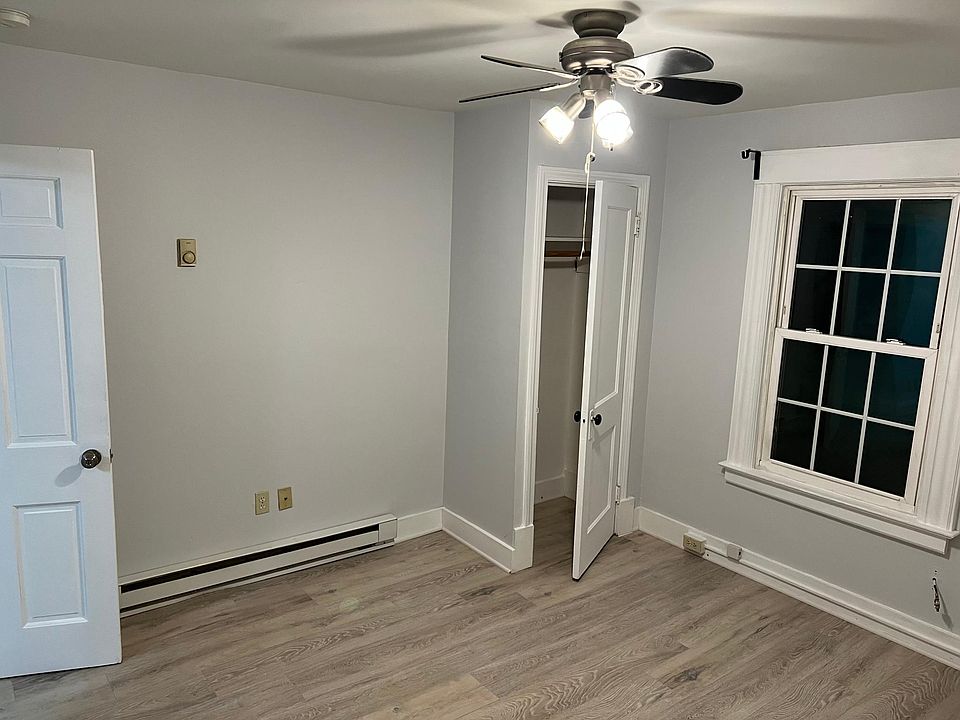 Bedroom 1 with new flooring and ceiling fan