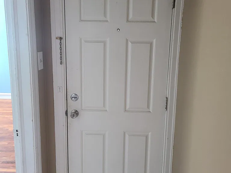 Front door closed from foyer. Living room to the left.