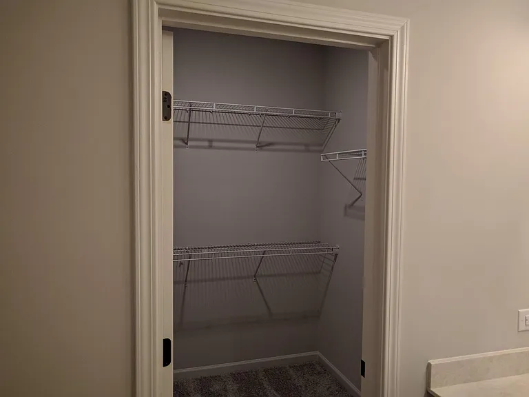Primary bedroom walk-in closet