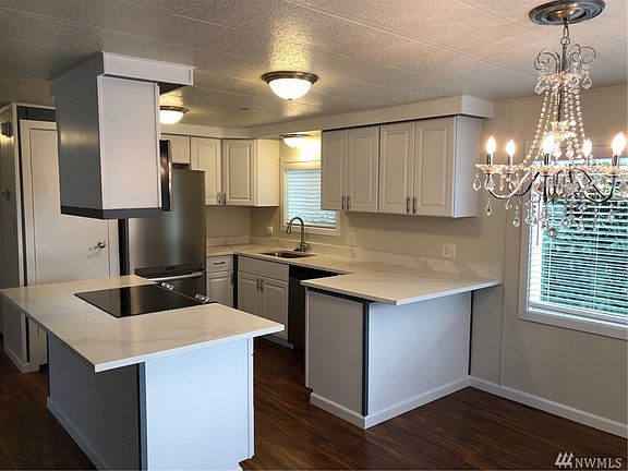 The newly renovated kitchen has the type of updates you'd see in much more expensive homes; Quartz counters; stainless steel appliances; new cabinets, sinks, and fixtures.