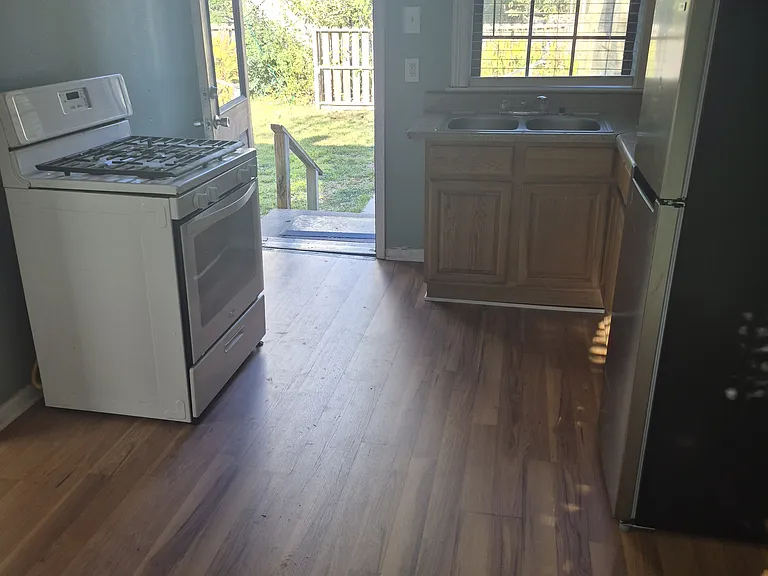 Dining area through kitchen, back door open.