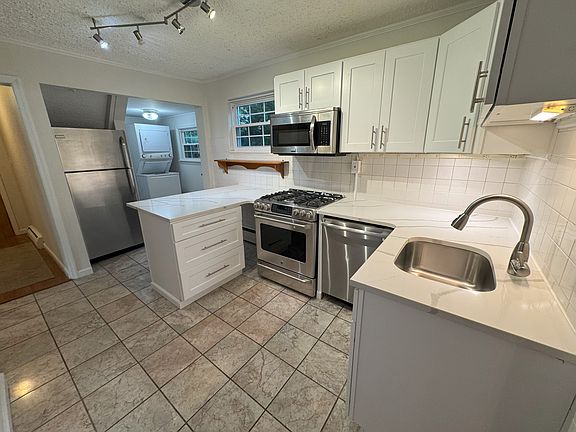 All Stainless Appliances with View of Laundry Room.
