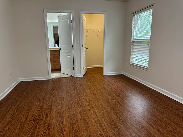 Main bedroom. Door on left to attached bathroom. Door on right is walk-in closet