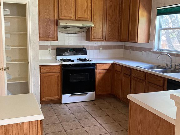 Kitchen with pantry and gas stove.
