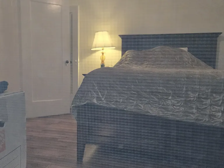 Second Bedroom with large walk in closet , wood floors.