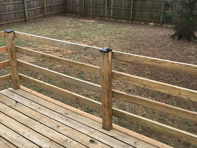 Fenced backyard with deck