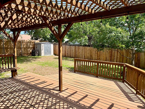 Large multi-level deck with covered pergola and smart LED string lights