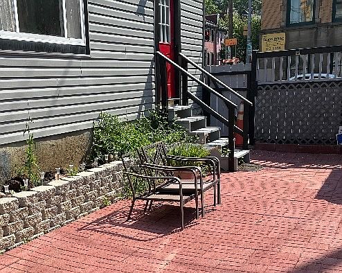 Private entry through gate of fenced courtyard