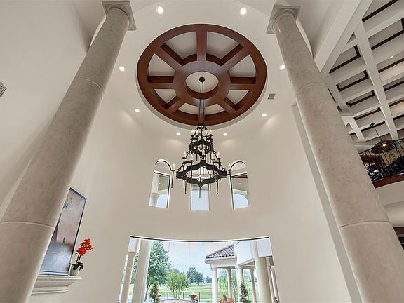 The stone columns, chandelier and dome ceiling in the formal living room are a piece of art.