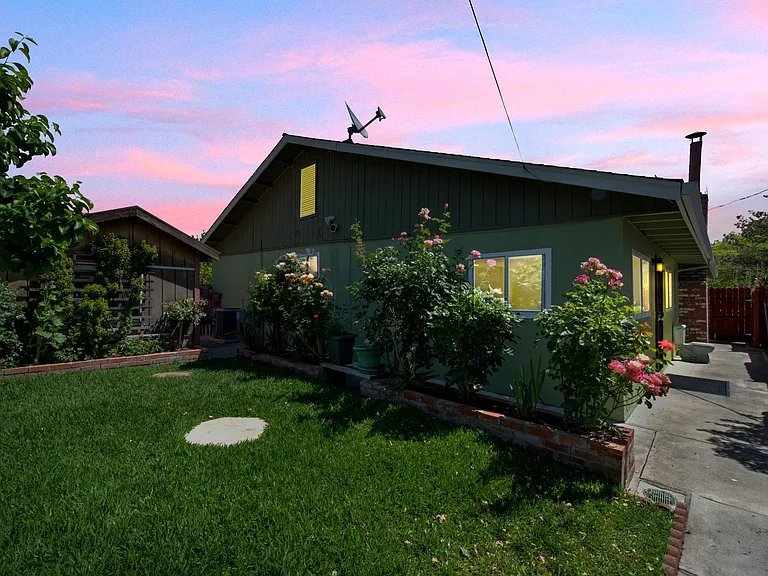 West view of the house at dusk, suspect photo-shopped picture.