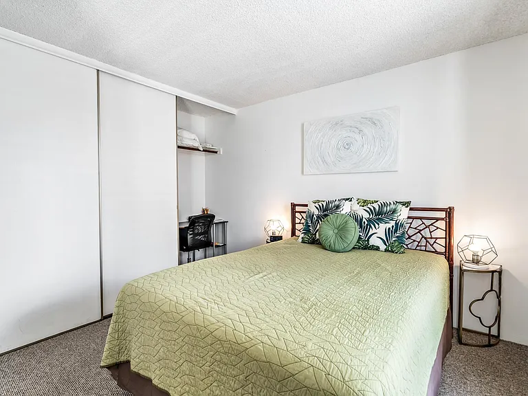 queen bedroom off living room; full length closets, lots of storage, desk and chair