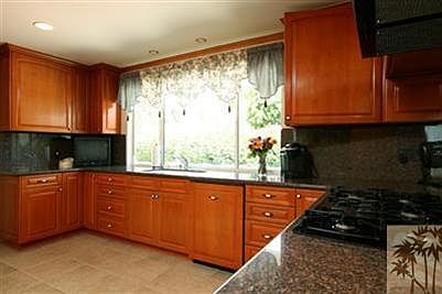 Kitchen with custom alder cabinets and KitchenAid appliances with cabinet fronts