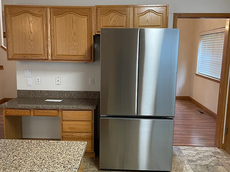 Tile in kitchen and laminated wood in the family room.