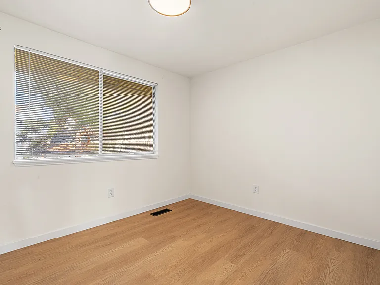 3rd bedroom with big window and double door closet