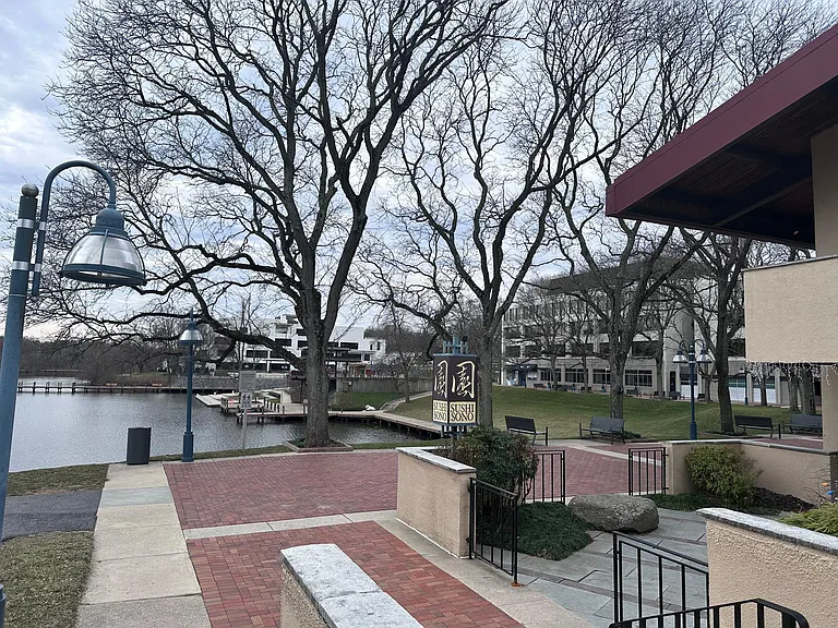 View of lakefront and Sushi Sono, steps from front entrance of condo