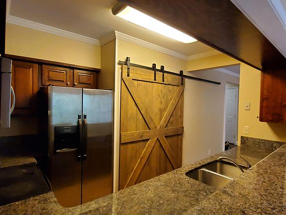 Barn doors cover washer/dryer/storage area. Washer dryer included unless you prefer to bring your own
