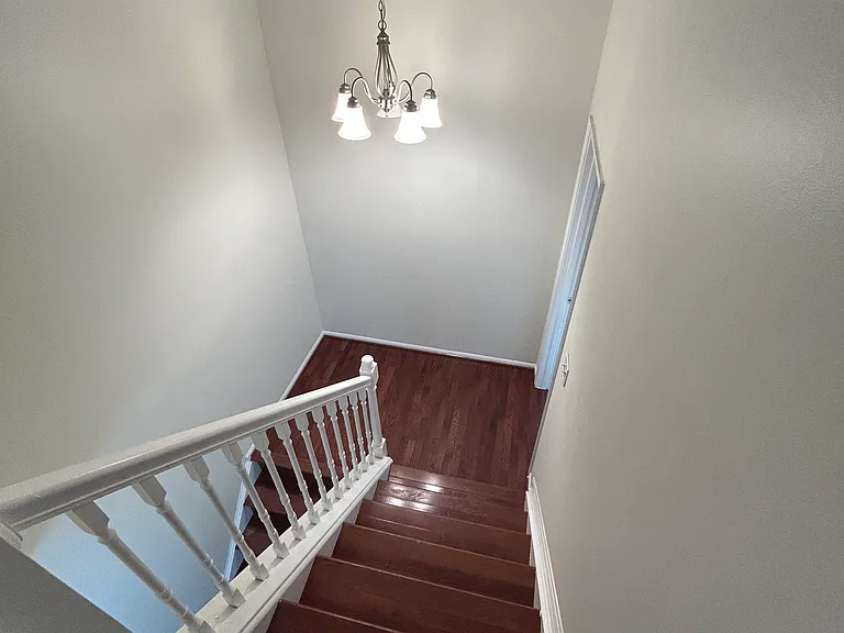 Down the stairs going to the main bedroom and down to living room