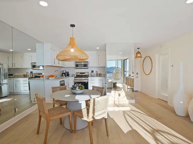 Bright dining area paired with a fully equipped kitchen, ideal for meals with an ocean view.