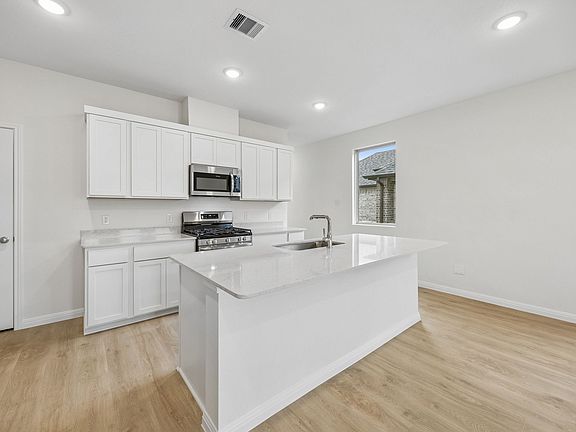 Kitchen in the Magnolia home plan by Trophy Signature Homes - REPRESENTATIVE PHOTO
