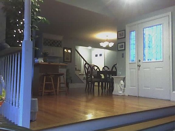 Kitchen and eating area, front door and secondary door to far left. 