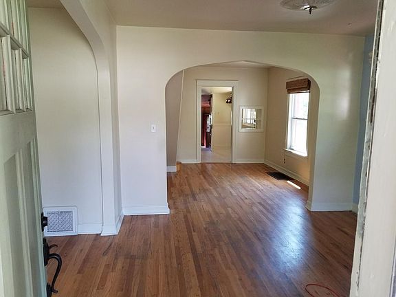 Walking in. looking through dining room into kitchen and bac