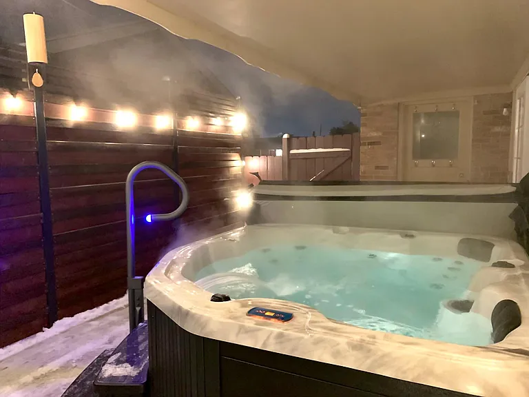 Covered back patio with hottub (entrances off of the garage/mudroom & the main level living room)