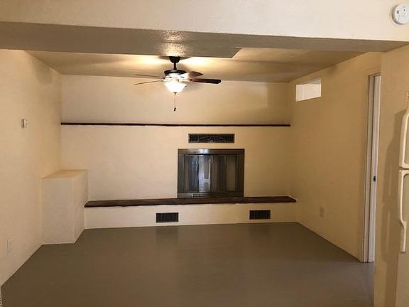 From living room looking toward far end of kitchen/fireplace/dining area. Door to right is second bedroom.