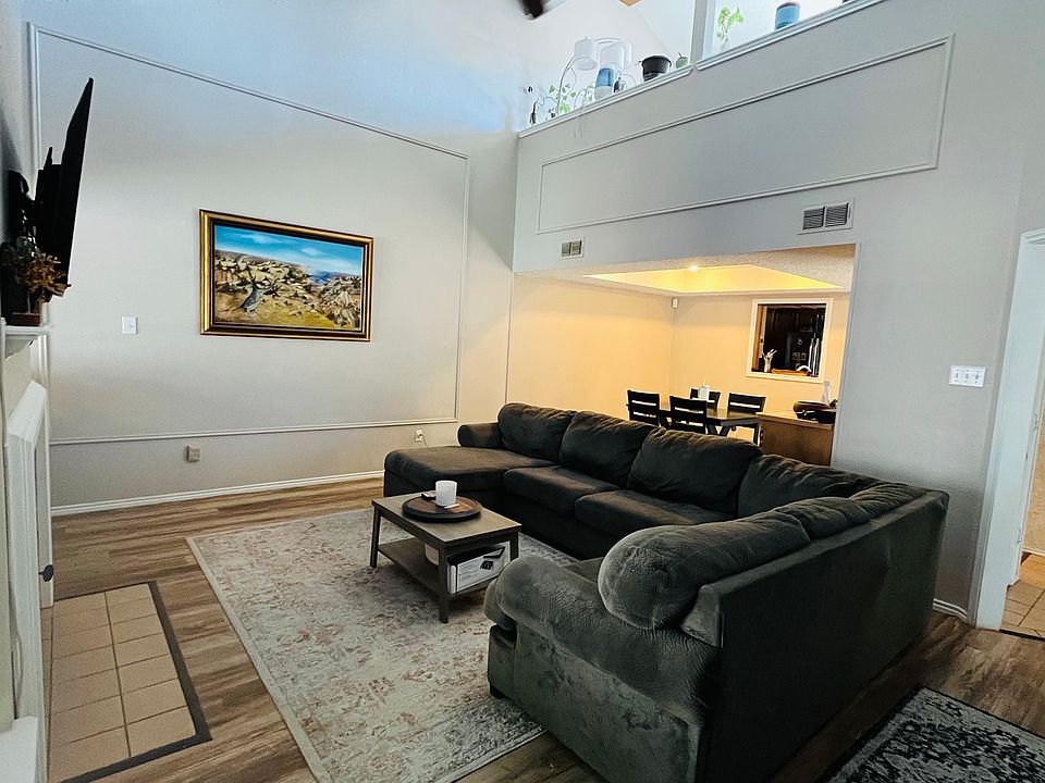 Living room has vaulted ceilings that open to the loft giving it an airy feeling. Wood floors.
