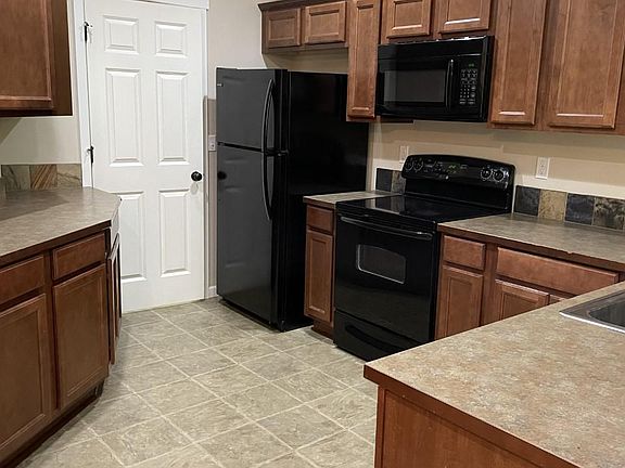 Kitchen is spacious and has ample counters for prep work.