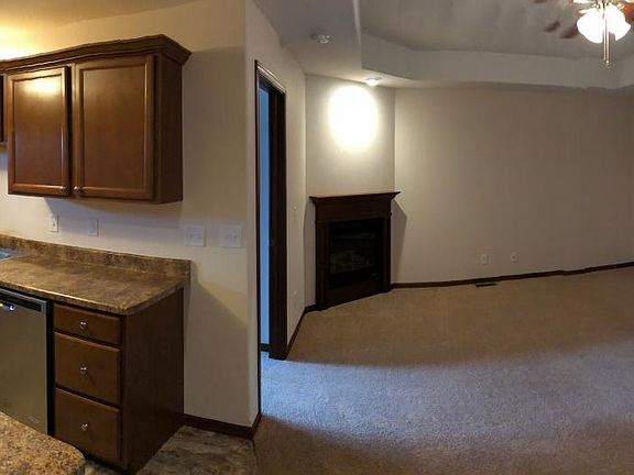Kitchen, bar, and upstairs living room area