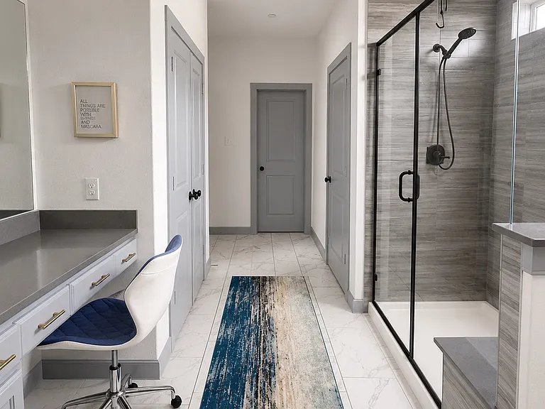 Primary bathroom with standing shower and dual sinks