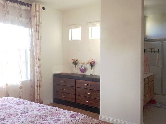 Another view of the primary bedroom, showing the adjoining bathroom