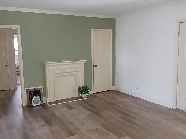 Living Room offers coat closet, closed off fireplace mantle, electric heating.