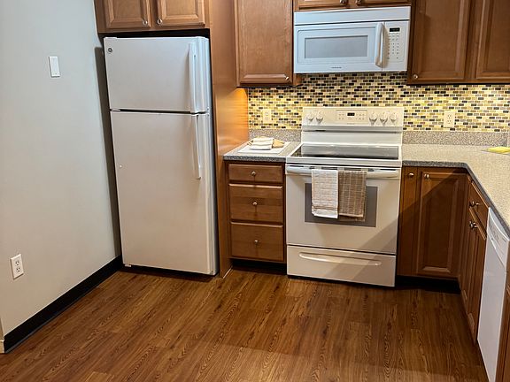 Appliances include frost-free fridge, glass top 5-burning stove, microwave hood, and dishwasher