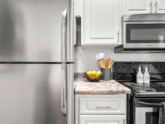 Our newly remodeled kitchens impress with timeless white cabinetry, elegant granite-style countertops, and a prominent white subway tile backsplash.