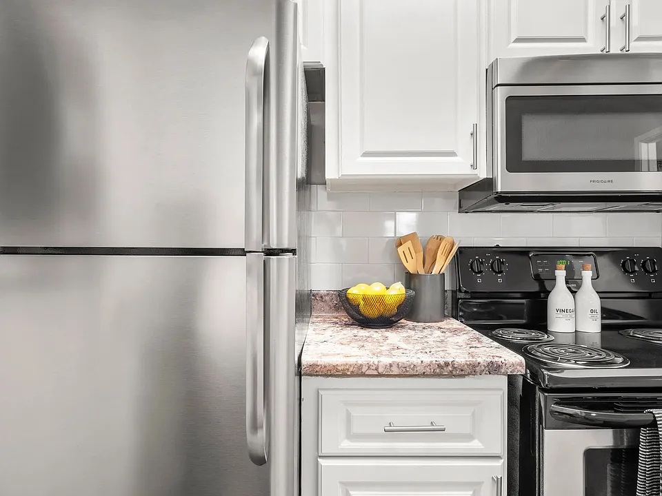 Our newly remodeled kitchens impress with timeless white cabinetry, elegant granite-style countertops, and a prominent white subway tile backsplash.