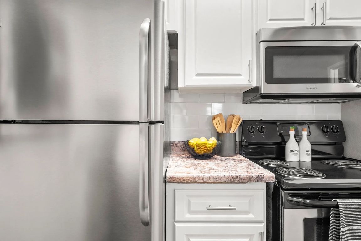 Our newly remodeled kitchens impress with timeless white cabinetry, elegant granite-style countertops, and a prominent white subway tile backsplash.